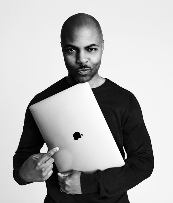 Cecil holding a mac laptop